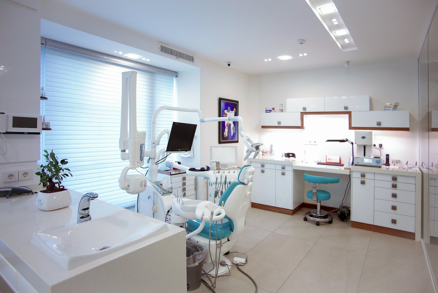 Calm modern clinic treatment room with a treatment chair and work area